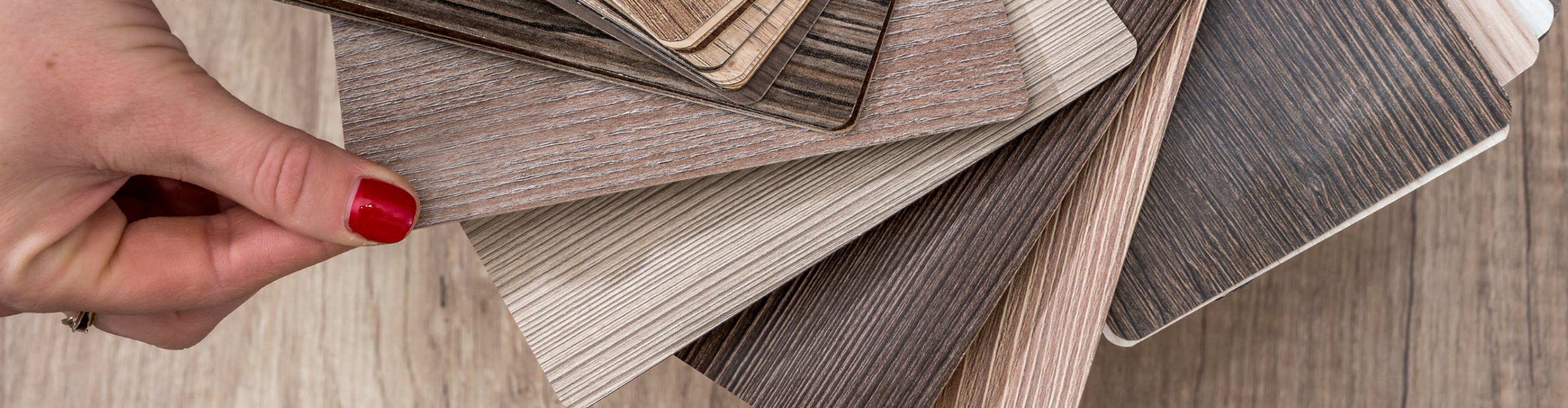 Close-up of luxury vinyl plank samples in wood-look finishes, showcasing stylish and durable flooring options. Explore our selection of luxury vinyl flooring at Carpet Master Carpet One.