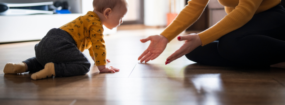 Baby crawling on durable hardwood flooring, a safe and stylish choice for family homes.