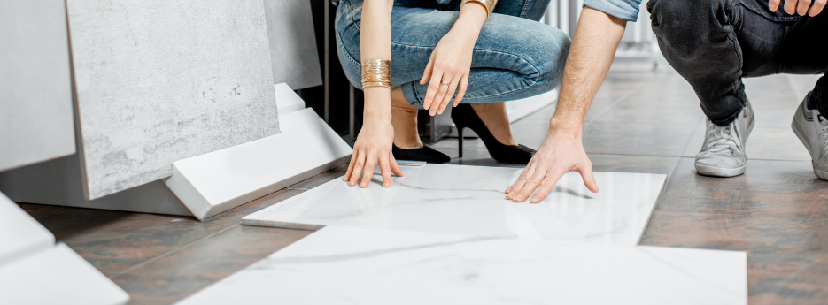 Customers exploring marble-look tile flooring, a durable and stylish option for any space. Discover 