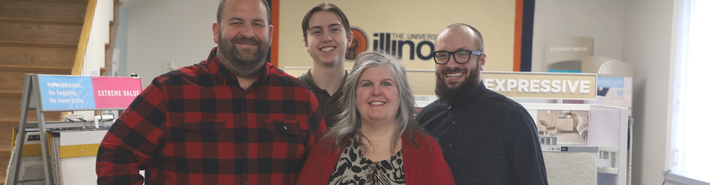 Friendly Carpet Master Carpet One team members standing together in the showroom, surrounded by flooring displays and a welcoming atmosphere.