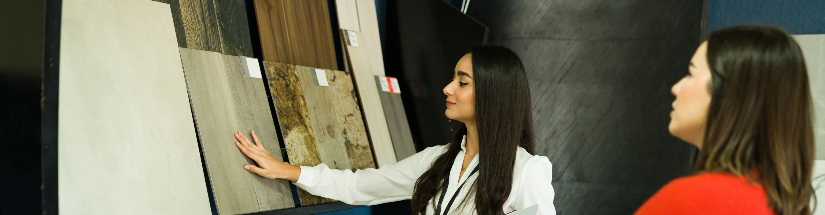 Customer exploring flooring samples with assistance from a knowledgeable consultant, highlighting a professional and friendly shopping experience for flooring solutions.